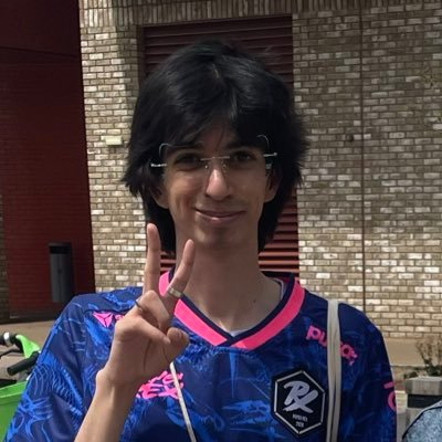 Rayyan smiling and holding up a peace sign